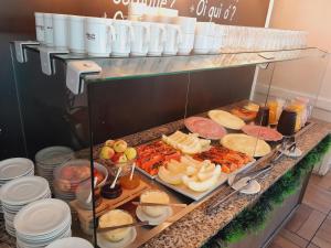 a buffet line with many different types of food at Casa de Pedra Mineira in Canela
