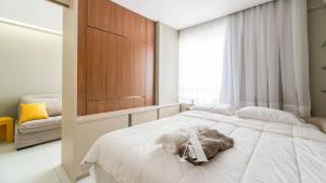 a bedroom with a bed with a dog laying on it at Flat in Boa Viagem leisure great location PM805 in Recife +21 photos