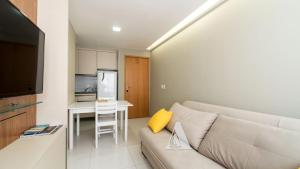 a living room with a couch and a table at Flat in Boa Viagem leisure great location PM805 in Recife
