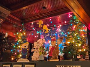 a room with christmas trees and christmas lights at Firehouse Inn in Barre