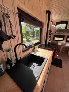 a kitchen with a black sink in a caravan at Berlin River Retreat in Berlin