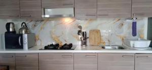 a kitchen with a sink and a counter top at Vimalla Hills 2br Private pool, bebas Jam cekin, cekout sesuai jam cekin 24 jam,081tiga80satu6415satu in Gadok 1