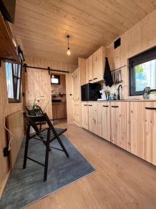 a kitchen with wooden cabinets and a chair in a room at Berlin River Retreat in Berlin +45 photos