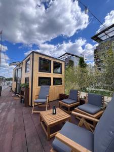 a tiny house on a roof with chairs and tables at Berlin River Retreat in Berlin