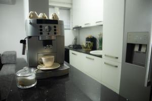 a kitchen with a coffee maker and a cup on a counter at Tina Home in Cluj-Napoca