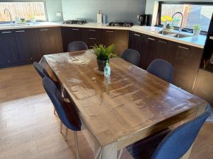 a wooden table in a kitchen with a bottle on it at Monash Ensuite room with shared kitchen & laundry in Oakleigh East +22 photos