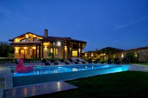 a swimming pool in front of a house at night at Villa Heaven Hills in Tsŭrkva