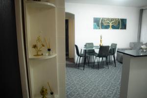 a living room with a table and a dining room at Tina Home in Cluj-Napoca +14 photos