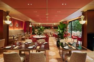 a restaurant with tables and chairs in a room at Bvlgari Hotel Paris in Paris