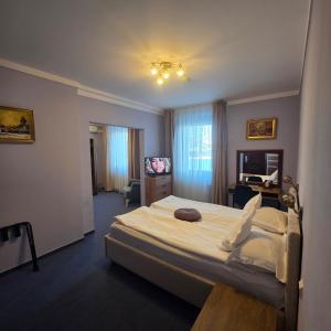 a bedroom with a large bed and a desk at Conacul Domnesc in Suceava