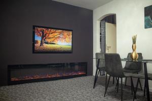 a living room with a fireplace with a tv above it at Tina Home in Cluj-Napoca