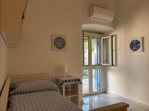 a bedroom with a bed and a window at Banfi's villa on the sea in Bisceglie