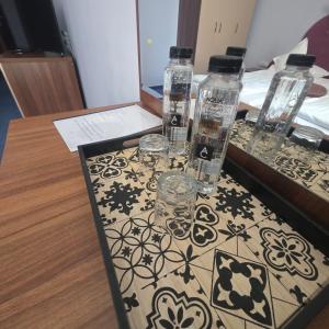 a table with bottles and glasses on top of it at Conacul Domnesc in Suceava +115 photos