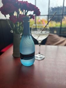 a bottle of wine and a glass on a table at The Swordfish Inn in Penzance +8 photos