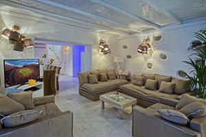 a large living room with couches and a tv at Zinas Villas in Fanari