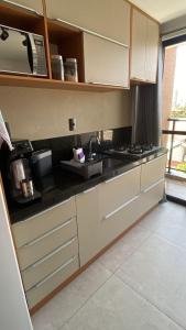 a kitchen with a sink and a stove at Flat Beach Way caminho da praia in Cabedelo