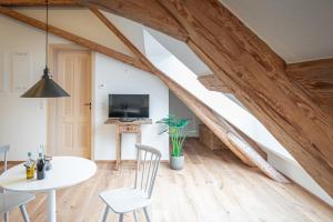 a room with a table and chairs and a tv at tobel 1853 apartments in Leutkirch im Allgäu