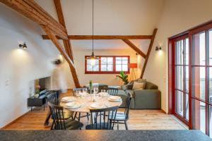 a dining room and living room with a table and chairs at tobel 1853 apartments in Leutkirch im Allgäu