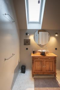 a bathroom with a sink and a mirror at tobel 1853 apartments in Leutkirch im Allgäu +46 photos