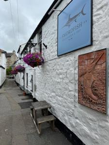 a sign on the side of a building at The Swordfish Inn in Penzance