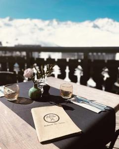 a table with two wine glasses and a napkin on it at Hotel Le Portillo in Val Thorens +21 photos