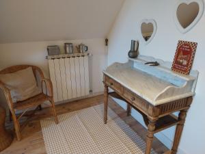 a room with a desk and a chair and a table at La chambre du Villard in Saint-Béron