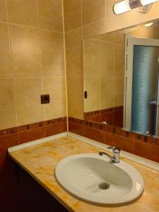 a bathroom with a sink and a mirror at Hostel By the Hill in Veliko Tŭrnovo