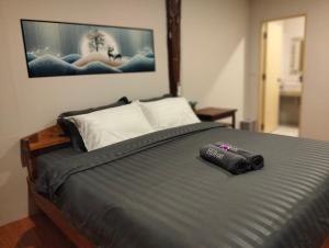 a camera laying on a bed in a bedroom at Koh jum Mutu Home Stay in Ban Ko Phrao