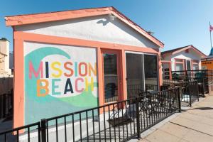 a small building with a mission beach sign on it at Beachside Bungalow steps from sand in San Diego