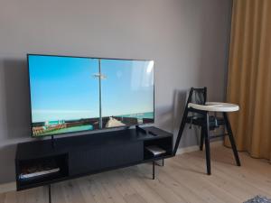 a large aquarium sitting on a stand next to a chair at Spacious and quiet 2BR apartment in Tartu