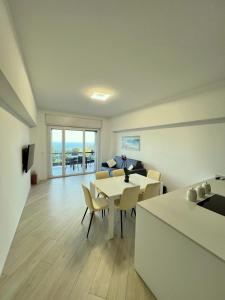 a living room with a table and chairs and a couch at Bergeggi Sea View Apartment - Torre del Mare in Bergeggi