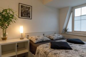 two beds in a room with a window at Vila Rajska ptica in Bled