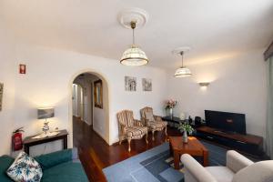 a living room with a couch and a table at Violeta House in Funchal
