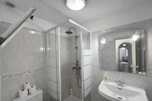 a bathroom with a shower and a sink and a toilet at Violeta House in Funchal