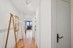 a staircase in a room with a white wall at Ramoni Apartments - NaturTraum Kniebis in Freudenstadt