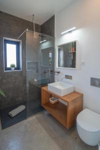 a bathroom with a sink and a toilet and a shower at BaliHouse by Aura Collection in La Oliva +12 photos