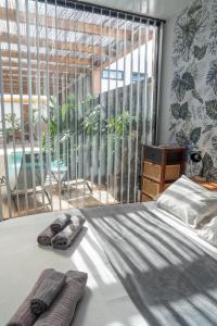 a bedroom with a bed with two towels on it at BaliHouse by Aura Collection in La Oliva