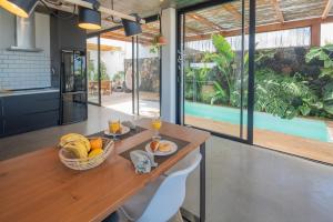 a dining room with a table with a basket of fruit at BaliHouse by Aura Collection in La Oliva