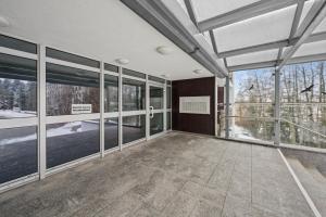 an empty room with large windows in a building at Ramoni Apartments - NaturTraum Kniebis in Freudenstadt +2 photos