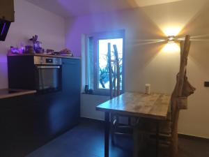 a kitchen with a wooden table and a window at Haus Auszeitblick in Bad Bentheim