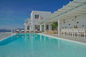 a villa with a swimming pool and a house at Zinas Villas in Fanari