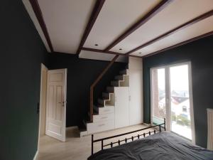 a bedroom with a bed and a stair case at Haus Auszeitblick in Bad Bentheim