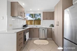 a kitchen with a sink and a dishwasher at Dean Park 2-Bed Unit in Deer Park +3 photos