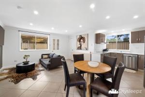 a kitchen and living room with a table and chairs at Dean Park 2-Bed Unit in Deer Park