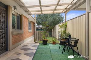 a patio with a table and chairs on it at Dean Park 2-Bed Unit in Deer Park