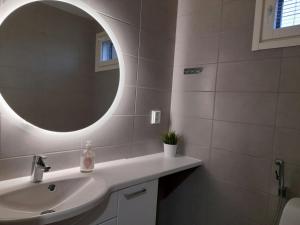 a bathroom with a sink and a mirror at Spacious Apartment for 4 with Sauna in Oulu +4 photos