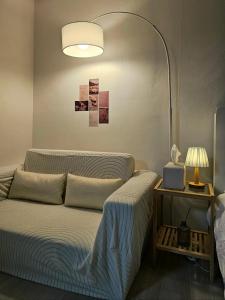 two beds in a room with a lamp and a bedskirts at Stay Onyu in Seoul