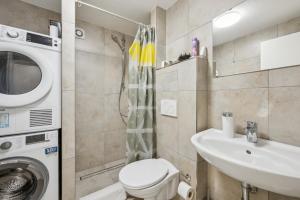 a bathroom with a washing machine and a sink at Ramoni Apartments - Bergzauber Kniebis in Freudenstadt +5 photos