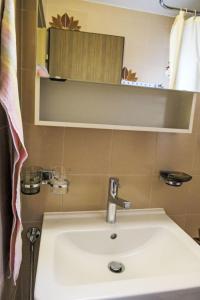 a bathroom with a sink and a mirror at Apartment Chesa Margretta by Interhome in Sils Maria