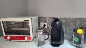 a kitchen counter with a toaster and a coffee maker at Appartement Duplex 40 M² in Fontenay-Trésigny